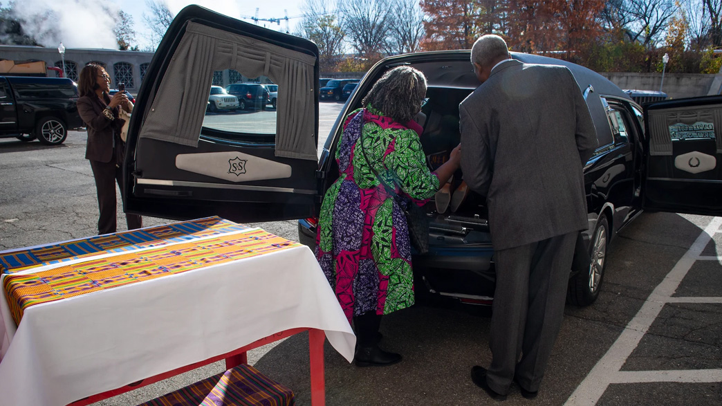 Members of the Family Representative counsel cover ancestral remains to return them to Richmond